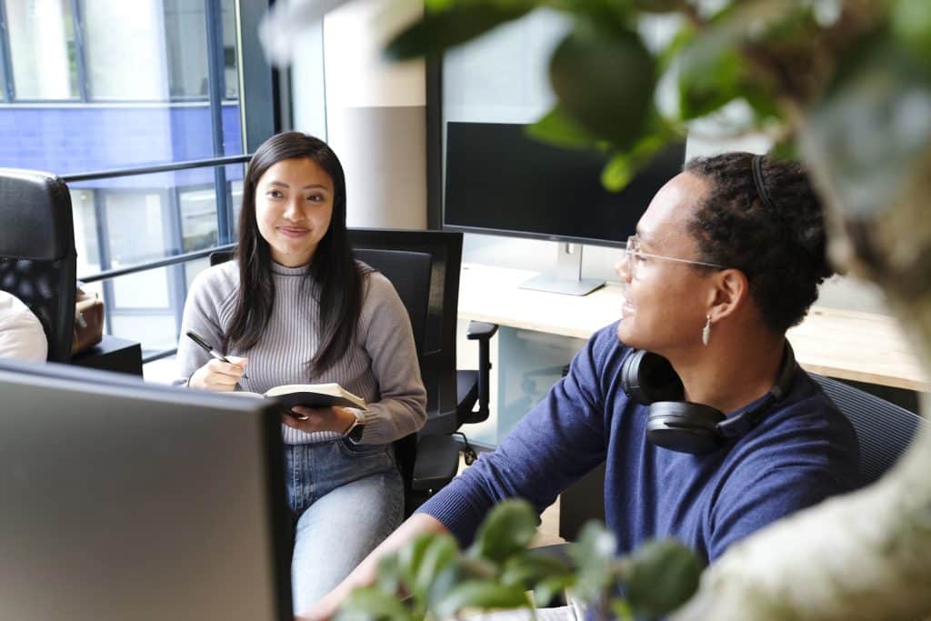 a man and woman sitting at a desk